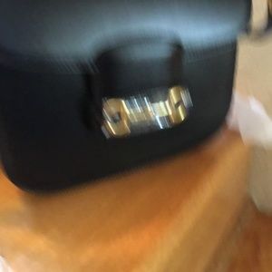 Black leather bag with equestrian motif